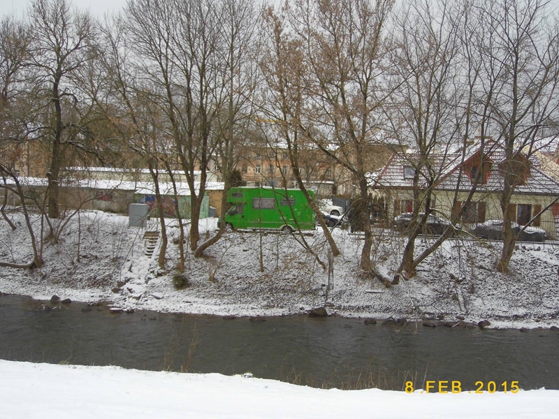 Green bus on the Vilnele in winter